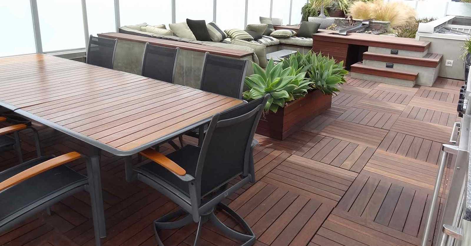 Roof top patio area with deck surfaces of Ipe wood and teak furniture, wood planter boxes and railings
